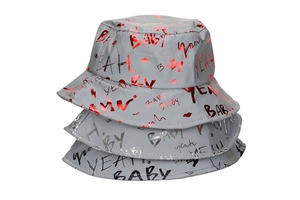 Detail of three bucket hats with reflective BABY graffiti print in red silver and black