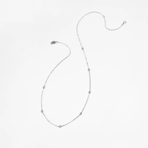 Macro detail of S925 sterling silver chain featuring round cubic zirconia stone accents