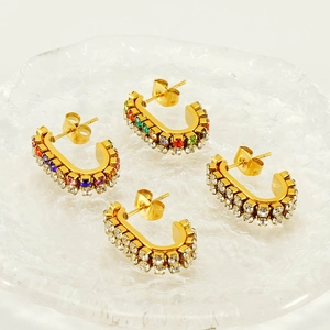 Detailed shot of gold plated U-shaped earrings with colorful and clear zircon stones