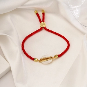 Adjustable red rope bracelet with natural shell charm and gold leaf slide clasp