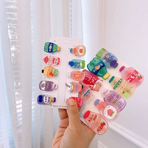 Close-up of cute cartoon soda bottle hair clips set in various bright colors
