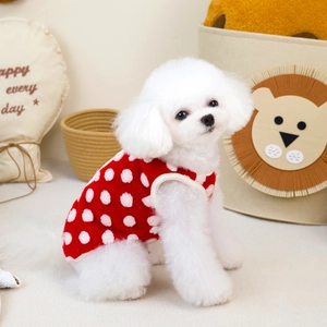 Detail view of red pet fleece vest with white 3D polka dots on a white puppy model