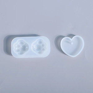 Detail view of translucent cat paw and heart shaped silicone resin molds for DIY jewelry