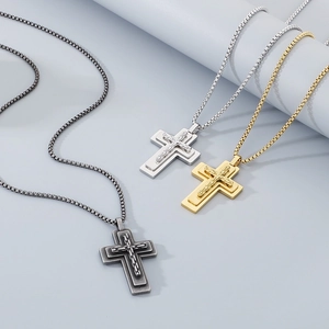 Detailed close-up of multi-layer cross necklaces in gold silver and vintage grey finishes