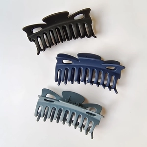 Set of three large matte bow hair claws in black, dark blue, and grey blue colors