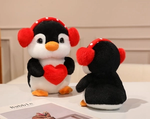 Front and back view of plush penguin doll with red heart and polka dot earmuffs
