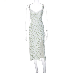 Detail of white floral sundress showing delicate lace neckline and green flower patterns