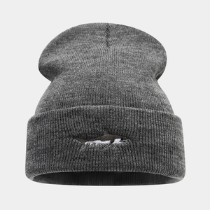 Close-up of high-quality grey knit beanie featuring detailed shark embroidery on cuff