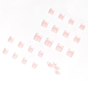 Uñas postizas cortas estilo francés con base rosa nude y puntas blancas, set de 24