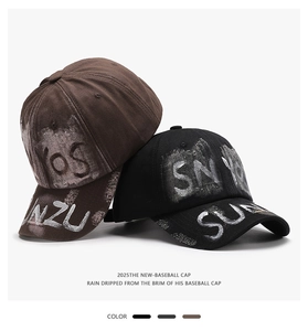 Close-up of graffiti lettering on vintage washed cotton baseball caps in brown and black