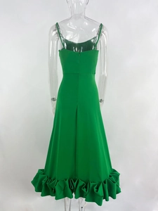 Detail of emerald green backless evening gown featuring a ruffled hem and invisible zipper
