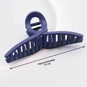 Detail view of 11cm matte navy blue hair claw clip with cross design and size scale