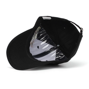 Detailed interior of a black polyester baseball cap showing sweatband and metal buckle