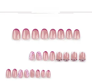 Detailed view of 24pcs short oval fake nails with French tips, marble art and rhinestones