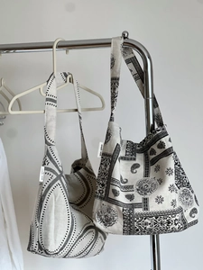 Macro shot of cotton linen tote bags featuring paisley and geometric patterns