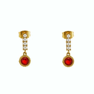 Detail view of gold drop earrings with vertical small pearls and red faceted stones