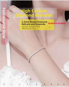 Detail view of a 2.5mm round-cut silver tennis bracelet worn on a woman's wrist