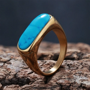 Macro shot of gold-plated ring with turquoise inlay on natural wood background