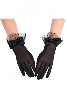 Detail of black lace bridal gloves featuring polka dot mesh and satin bow accents