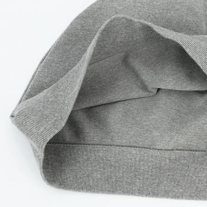 Macro detail of the gray ribbed knit hem showing elastic texture for sports beanies