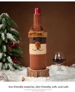 Detail of knitted Christmas wine bottle cover featuring a reindeer design and soft textures