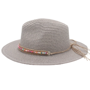 Close-up of grey Panama straw hat with colorful beads and decorative side bow detail