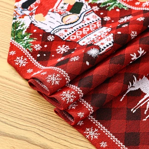 Detailed view of red and black buffalo plaid Christmas table runner with reindeer pattern