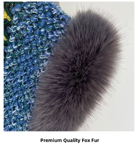 Detailed close-up of colorful chunky knit texture and soft dark grey faux fox fur pompom