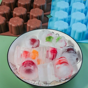 Detail of 6-cavity flower silicone mold with fruit-filled ice cubes in a bowl