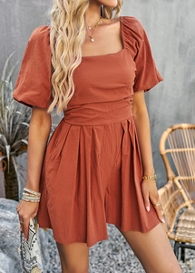 Detail view of square neck rompers with puff sleeves and tie waist in caramel color