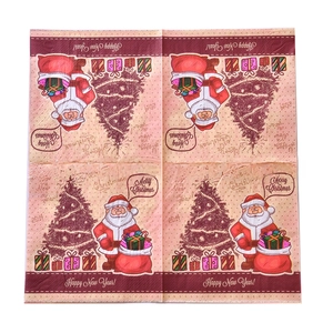 Close-up of Christmas napkins featuring Santa, trees, and gold foil festive patterns