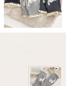 Close-up of white lace ruffle cuffs and cute cat pattern on gray knit crew socks