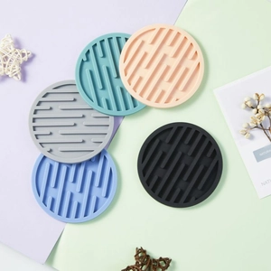 Thick round silicone coasters in five colors with non-slip grooved design for heat insulation