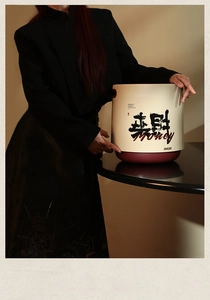 Close-up of beige trash bin featuring festive Chinese calligraphy and prosperity message
