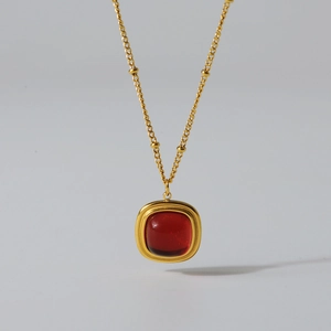 Gold-plated titanium steel necklace with a red square gemstone pendant and bead chain