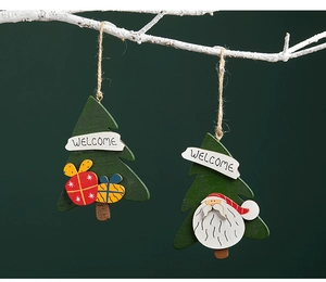 Detail of wooden Christmas tree pendants with Santa and gift box on rustic white branches