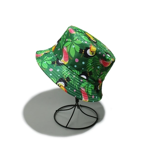 Close-up of tropical toucan and leaf print on canvas green bucket hat material