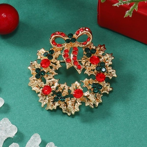 Detailed view of Christmas wreath brooch with sparkling red and green crystals