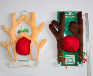 Detail view of plush Christmas reindeer car antlers and red nose with a size reference ruler