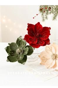 Close-up of elegant flocked Christmas magnolia with glitter edges on white table