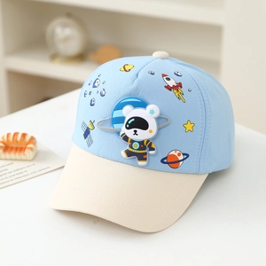 Detail view of space bear embroidery and rocket patterns on child's baseball cap