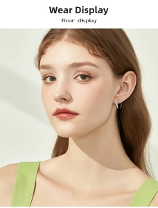 Elegant silver s925 sterling silver moissanite earrings worn by a model in natural light