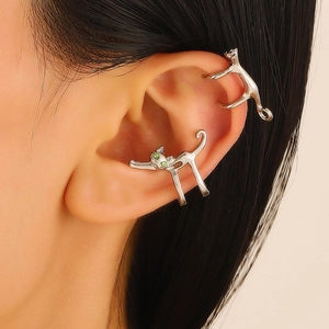 Silver cat ear cuffs with green zircon eyes shown on model in a close-up profile view