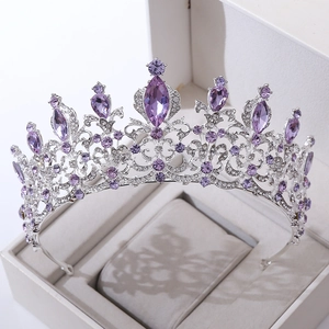 Macro detail of luxury silver bridal crown with purple rhinestones in a white gift box