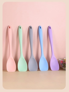Detailed view of colorful silicone salad spoons with hanging holes in five pastel tones