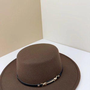 Detail of dark brown wool fedora with a black leather band and gold chain buckle accent