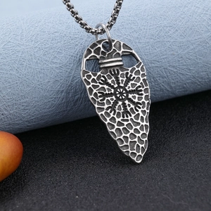 Macro shot of Viking compass arrow pendant in antique silver finish with detailed engravings