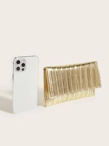 Detailed size comparison of gold pleated envelope clutch next to a smartphone