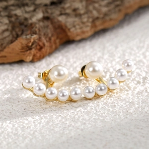 Elegant Korean style gold floating pearl earrings with white pearls in curved design