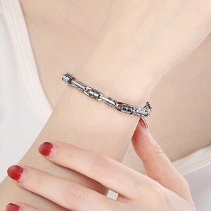 Detailed shot of Byzantine stainless steel bracelet on wrist showing silver link texture